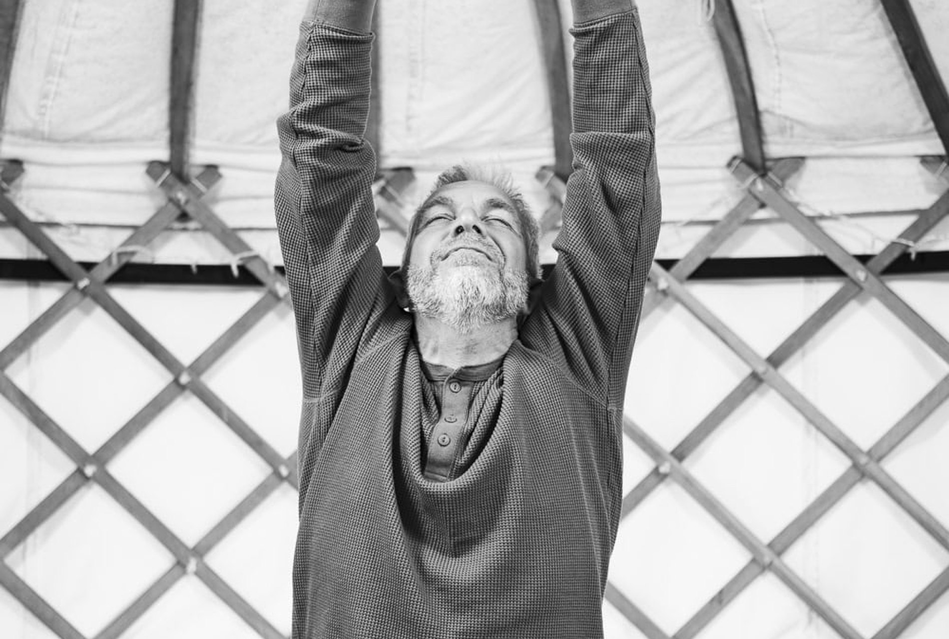 A practitioner working through a movement, photographed from below