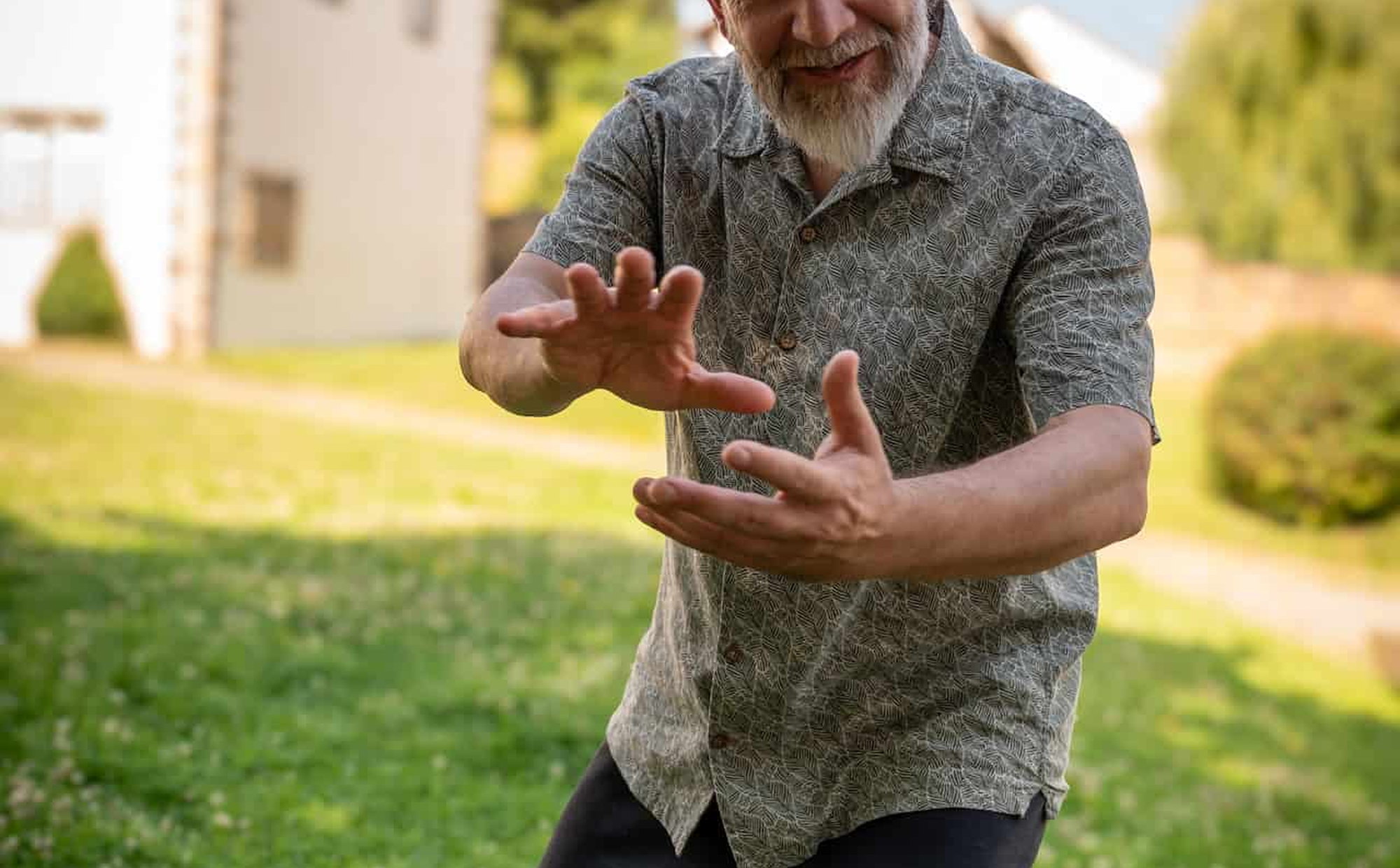 Practising Qi Gong in a garden beside an old building