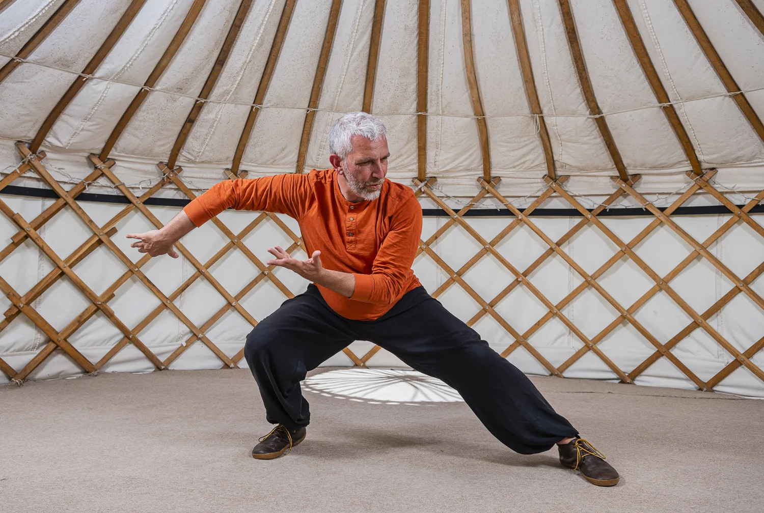 John Millar demonstrating a low, wide stance in the yurt