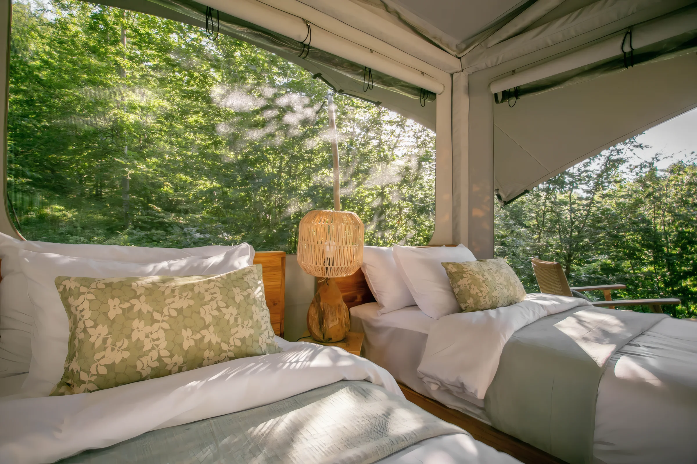 A glamping house bedroom at ašuma retreat, opening onto the forest